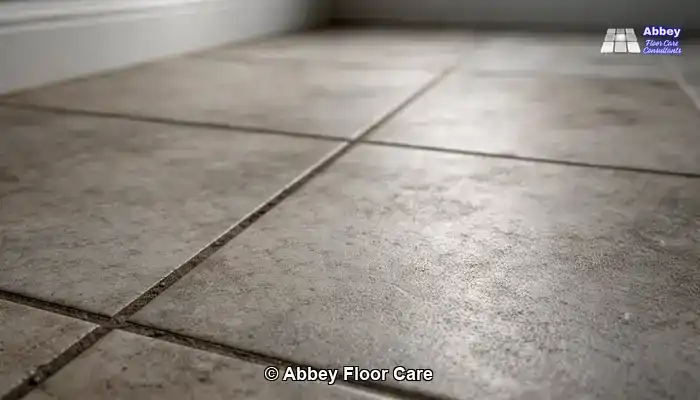 Porcelain Tile Restoration in Surrey: Close detail of textured porcelain tiles with surface haze and dark grout lines.