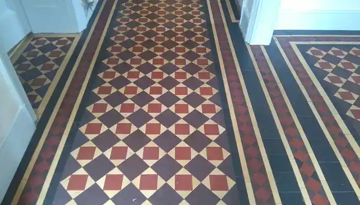 Restored Minton tile hallway with recovered colour and clear geometric pattern